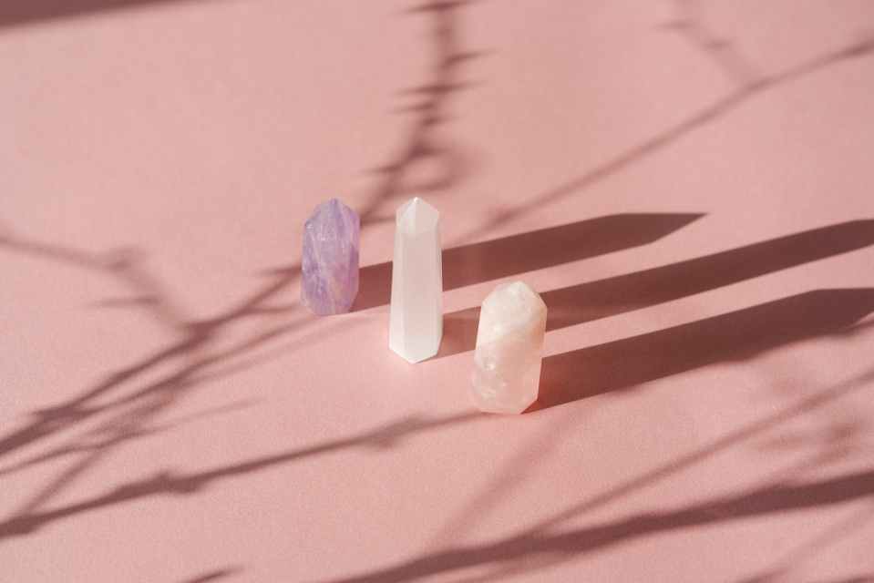 stone crystals casting a shadow on the white surface